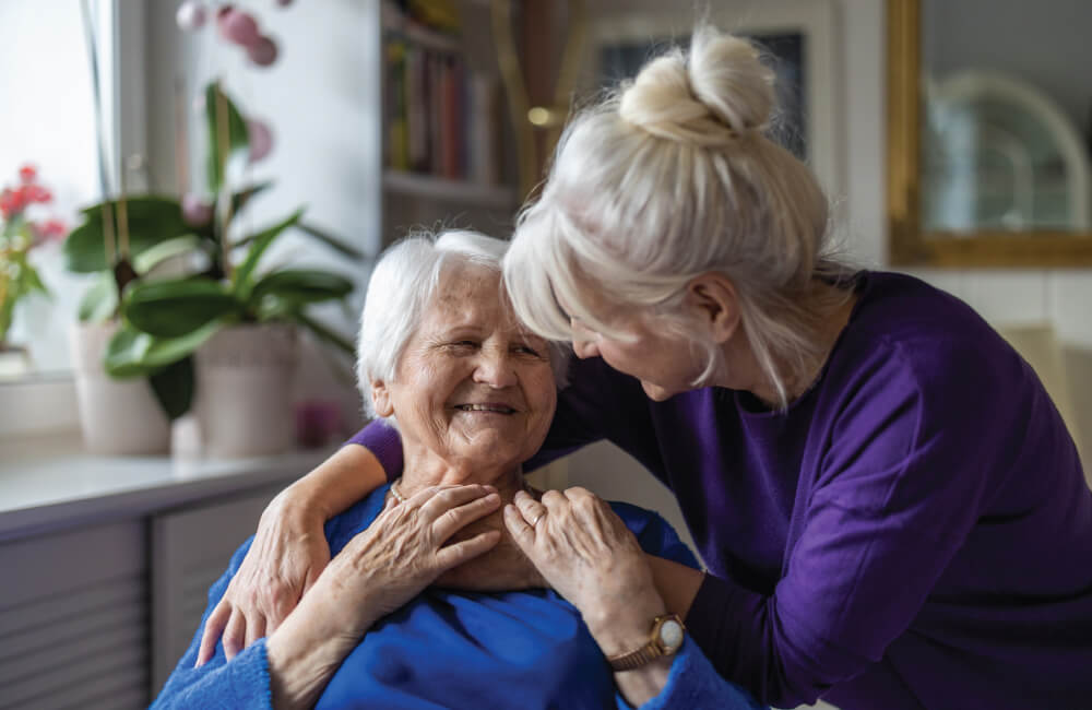 giving a hug to a senior woman