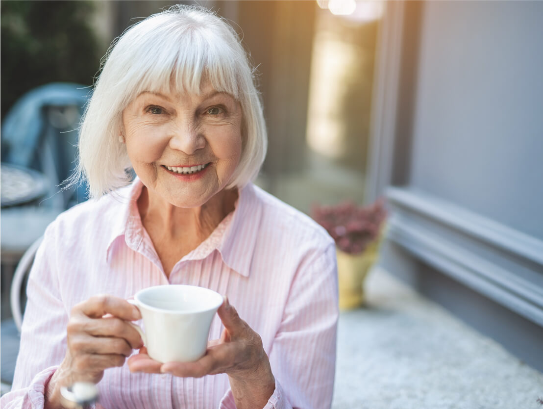 senior woman holding a coffee mug