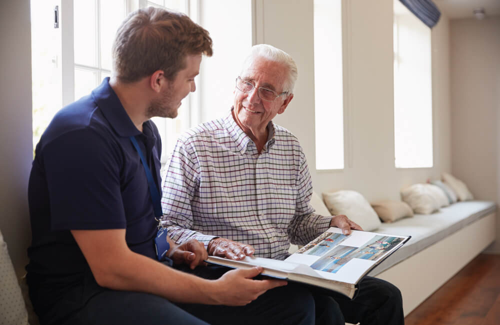 Senior man reading a book with an employee