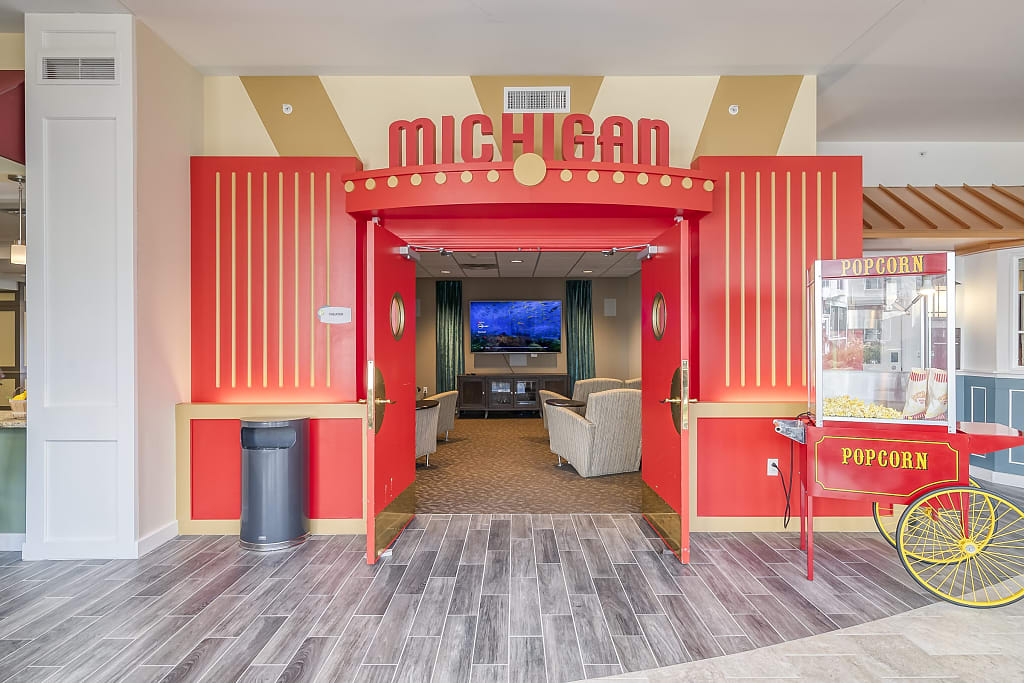 Community movie theatre entrance with popcorn machine and large Michigan sign